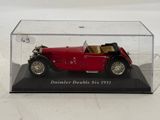 a red model of a car in a clear case