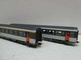 deux wagons placés côte à côte sur une surface blanche