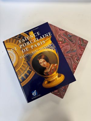 two books sitting on top of each other on a table