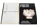 an old book with a silver bowl on top of it