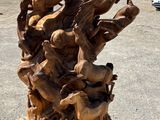 a sculpture made of wood sitting on a pallet in a parking lot