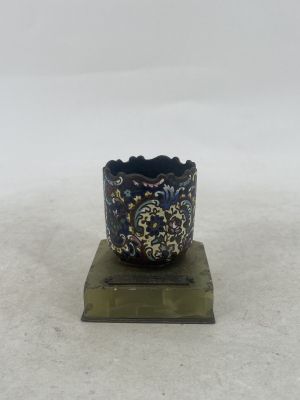 a small blue bowl sitting on top of a wooden stand