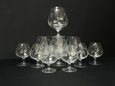 several empty wine glasses are arranged in a pyramid on a black surface