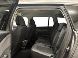 the back seats of a car with the door open in a parking lot