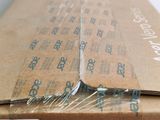 a box with a pair of scissors in it sitting on a table