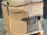 boxes stacked on a pallet in a warehouse with a black wall in the background
