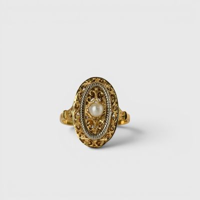 an image of a gold ring with a pearl in the center