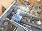 many different types of metal parts sitting on the ground