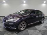 a purple car is parked on a checkered floor in a garage