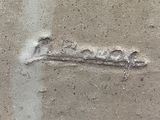 a close up of a piece of metal on a cement surface