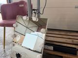 a suitcase sitting on a pallet next to a chair