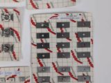 several pieces of paper with red and black designs on them