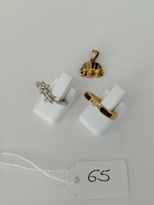 two pairs of gold and white cuff rings and a tag