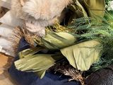 a teddy bear sitting on top of a pile of leaves