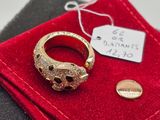 a gold ring with black and white diamonds on it