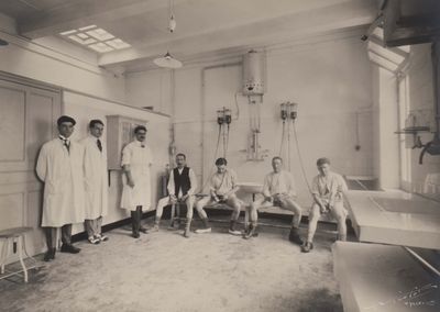black and white photograph of a group of men in a hospital room