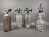 three old fashioned glass bottles are lined up against a gray background