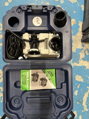 a blue case with wires and wires in it on the floor