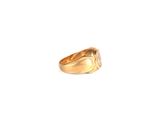 an image of a gold ring on a white surface