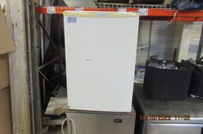 an image of a refrigerator in a warehouse with other appliances