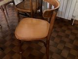 several chairs and a table in a room with a brick floor