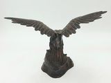 statue of an eagle with wings spread out on a white background