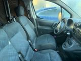 the interior of a small car with a steering wheel and a dashboard