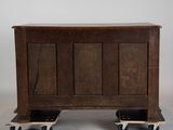 a small wooden chest on wheels on the floor