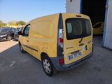 a yellow van parked in a parking lot next to a building