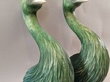 pair of green ceramic peacocks sitting on top of each other