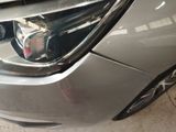a close up of a car ' s headlight and front bumper