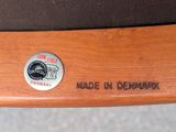 a close up of a wooden chair with a button on it