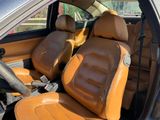 the interior of a car with tan leather seats and a steering wheel