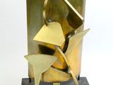 a metal sculpture of a bird on top of a base