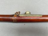 a close up of a wooden pipe with a brass handle