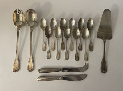 a lot of silver spoons and knives on the table