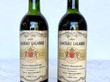 two bottles of wine sitting next to each other on a table