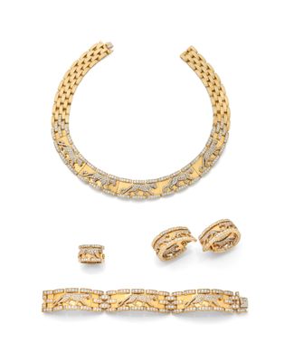 a gold and diamond necklace, bracelet, and ring