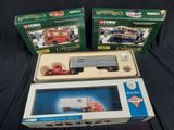 three boxed boxed toys of a truck and a bus on a black surface