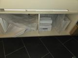 a small cabinet with a lot of papers on it