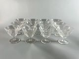 six clear wine glasses sitting on top of a table
