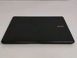the back of a black laptop computer sitting on top of a white surface