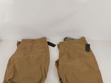 un pantalon marron posé sur une table blanche