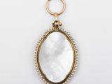 a gold and mother of pearl pendant