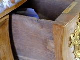 a wooden desk with a marble top and a drawer