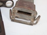 a small metal object on the table next to a pair of scissors
