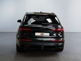 the rear end of a black audi qx parked in a room
