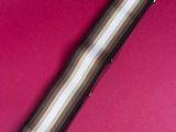 a brown and white striped hair band on a pink background