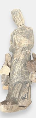 a statue of a woman sitting on a pile of rocks