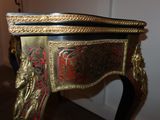 a small table with a gold and red decoration on it